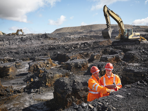 Workers Inspecting Coal In Mine --- Image by © Monty Rakusen/cultura/Corbis